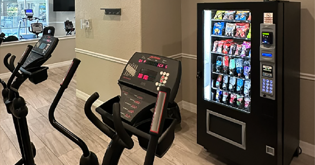 A vending machine in a gym stocked with healthy snack alternatives.