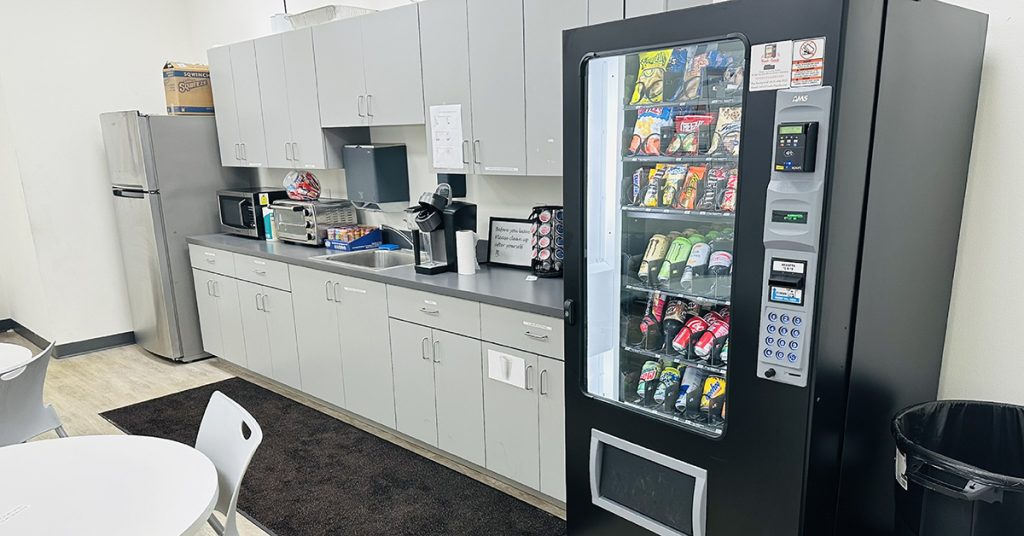 An office vending machine stocked with snacks and drinks for coworkers.